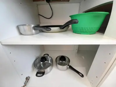 a shelf with two utensils and a green bowl at Old Town - 2 bedrooms Sołtyka S3 in Kraków