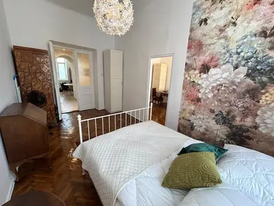 a bedroom with a bed with a painting on the wall at Old Town - 2 bedrooms Sołtyka S3 in Kraków
