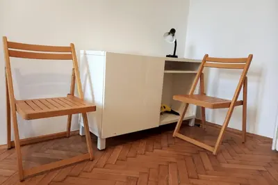 two wooden chairs sitting next to a desk with a desk at Old Town - 3 bedrooms Sołtyka S4 in Kraków