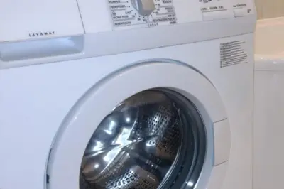 a white washing machine with its door open at Old Town - 3 bedrooms Sołtyka S4 in Kraków