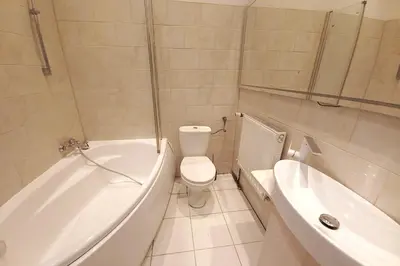 a bathroom with a tub and a toilet and a sink at Old Town - 3 bedrooms Sołtyka S4 in Kraków