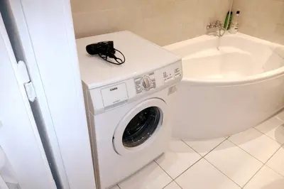 a camera sitting on top of a washing machine in a bathroom at Old Town - 3 bedrooms Sołtyka S4 in Kraków