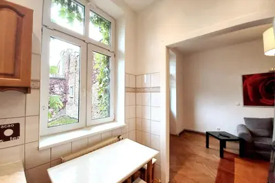 a living room with a bench and a window at Old Town - 3 bedrooms Sołtyka S4 in Kraków