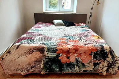 a bed with a colorful quilt on it in a bedroom at Old Town - 3 bedrooms Sołtyka S4 in Kraków