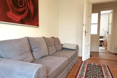 a living room with a gray couch and a red painting at Old Town - 3 bedrooms Sołtyka S4 in Kraków