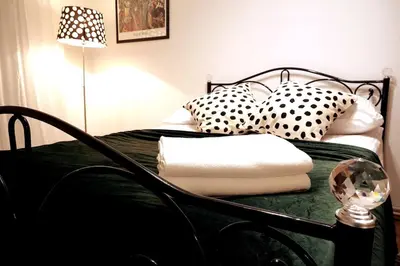 a bedroom with a bed with pillows and a lamp at Old Town - 2 bedrooms Sołtyka S6 in Kraków