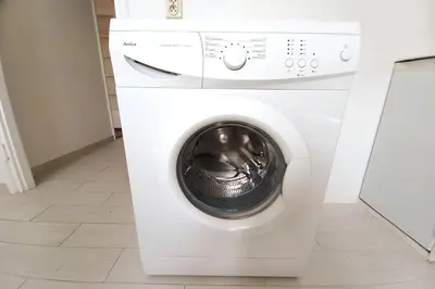 a white washing machine in a room at Old Town - 2 bedrooms Sołtyka S6 in Kraków