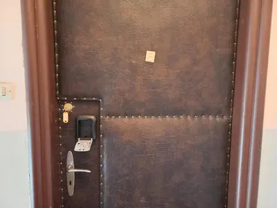 a brown door with a cell phone on it at Old Town - 2 bedrooms Sołtyka S6 in Kraków