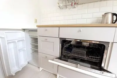 a kitchen with an oven in a white kitchen at Old Town - 2 bedrooms Sołtyka S6 in Kraków
