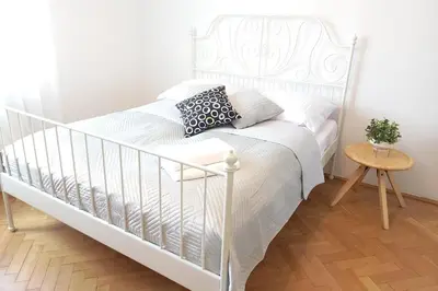 a white bed in a white bedroom with a table at Old Town - 2 bedrooms Sołtyka S6 in Kraków