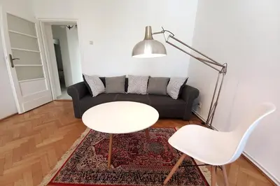 a living room with a couch and a table and chairs at Old Town - 2 bedrooms Sołtyka S6 in Kraków