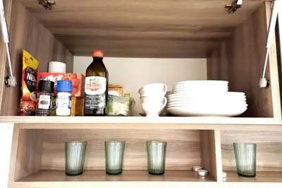 a shelf with dishes and bottles of alcohol and plates at Old Town Apt - Rzeszowska R6 in Kraków