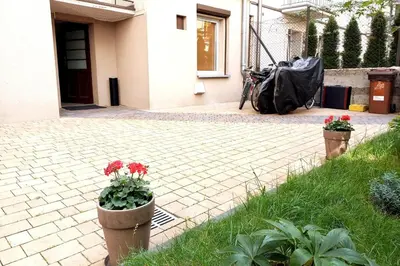 two pots of flowers in front of a house at Old Town Apt - Rzeszowska R6 in Kraków