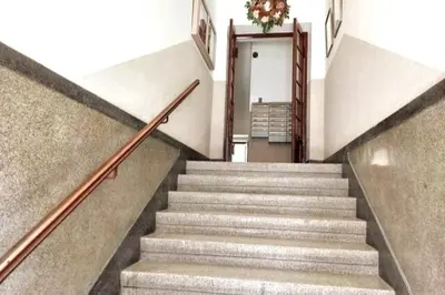 a staircase in a building with a plant on the wall at Old Town Apt - Rzeszowska R6 in Kraków