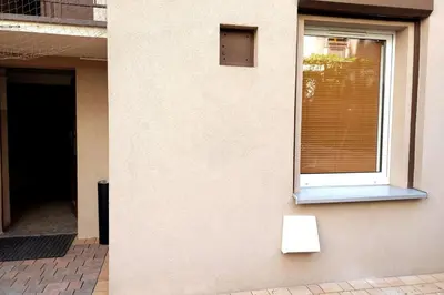 a window on the side of a building with a bench at Old Town Apt - Rzeszowska R6 in Kraków