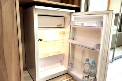 an open refrigerator with two bottles of water in it at Old Town Apt - Rzeszowska R6 in Kraków