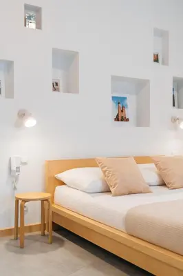 a bed with a wooden frame in a room at Native Apartments Krupnicza 7 in Kraków