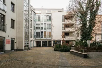 an empty street in a city with buildings at Native Apartments Krupnicza 7 in Kraków