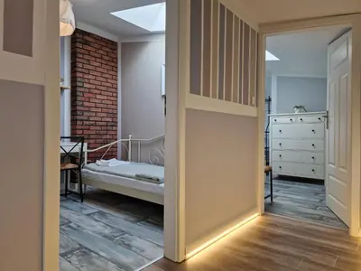 a door leading to a bedroom with a bed at NestingHigh apartment in Kraków