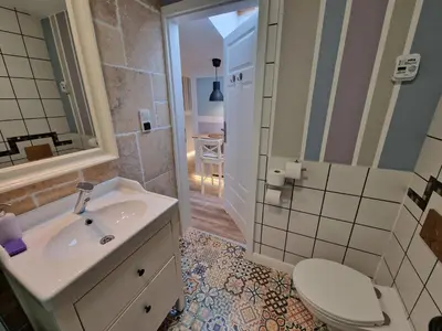 a bathroom with a sink and a toilet and a shower at NestingHigh apartment in Kraków