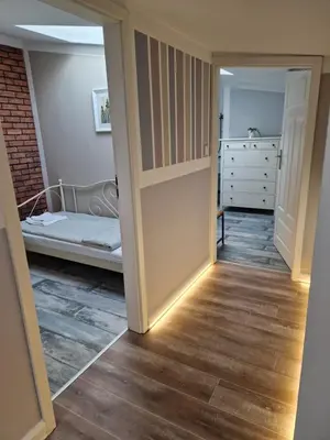 a hallway with a door leading to a bedroom at NestingHigh apartment in Kraków