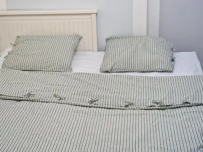 a bed with two pillows on top of it at NestingHigh apartment in Kraków