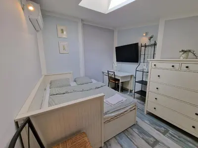 a small room with two beds and a desk at NestingHigh apartment in Kraków
