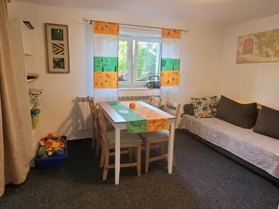 a living room with a table and a couch at Apartamencik Pod Krokusem 2 in Rabka