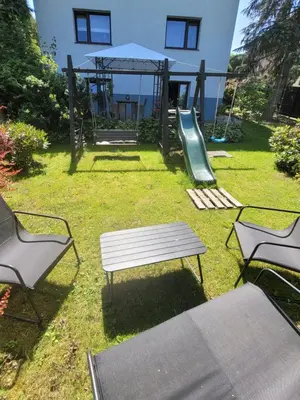 a park with a bench and a playground with a slide at Apartamencik Pod Krokusem 2 in Rabka