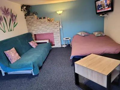 a living room with two beds and a couch at Apartamencik Pod Krokusem 2 in Rabka