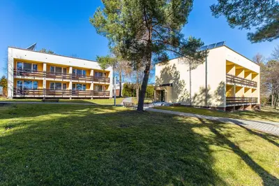 a building with a tree in front of it at Hotel Dobczyce in Dobczyce