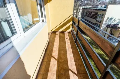 a balcony with a wooden floor and a window at Hotel Dobczyce in Dobczyce