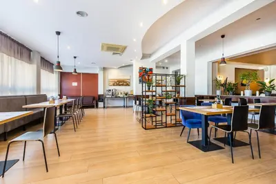 a restaurant with tables and chairs in a room at Hotel Dobczyce in Dobczyce