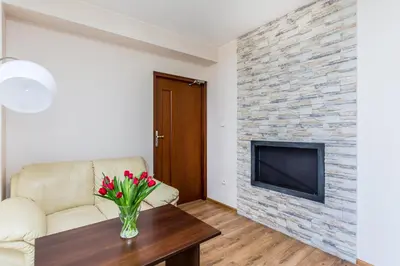 a living room with a couch and a fireplace at Hotel Dobczyce in Dobczyce