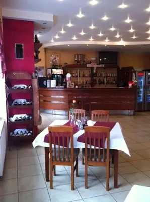 a dining room with a table and chairs in a restaurant at Zajazd Pasja in Sławków