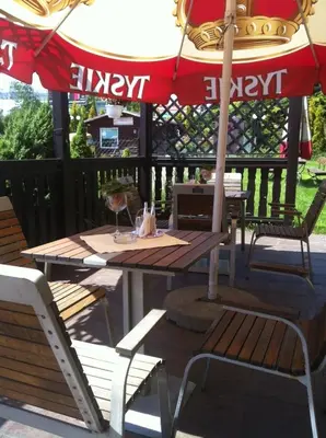 a table and chairs and an umbrella on a patio at Zajazd Pasja in Sławków