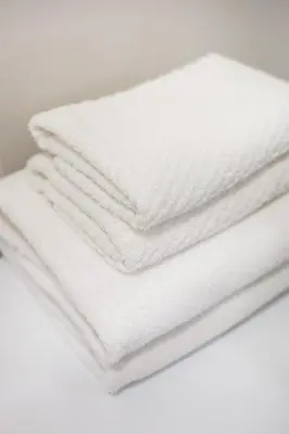 a pile of white towels stacked on top of each other at City of the Kings-Milford Sound in Kraków