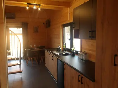 a kitchen with a sink and a counter top at Domki na Stodoliskach in Kasinka Mala