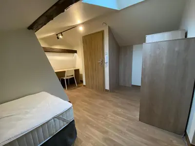 a small room with a bed and a desk at Yourplace Central Apartments in Kraków