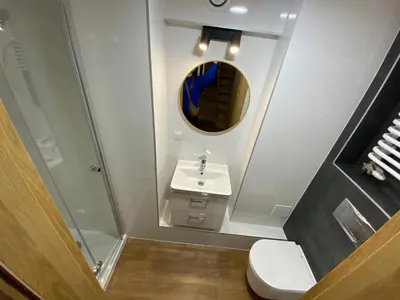a bathroom with a toilet and a sink and a mirror at Yourplace Central Apartments in Kraków