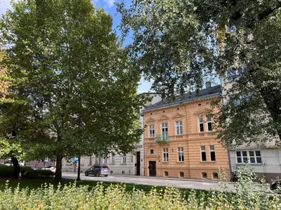 a large brick building with a car parked in front of it at Yourplace Central Apartments in Kraków