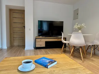 a living room with a coffee table and a tv at Zinc FAM in Oświęcim