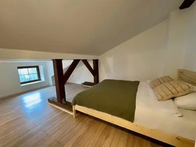 a bedroom with a large bed in a room at Cozy Cottage in Oświęcim