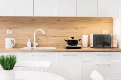 a kitchen counter with a microwave and a sink at City of the Kings-Riverside WT2 in Kraków