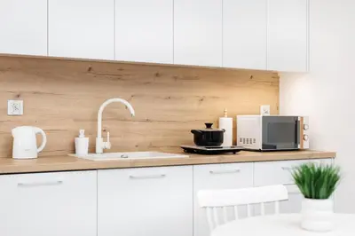 a kitchen counter with a microwave and a sink at City of the Kings-Riverside WT2 in Kraków