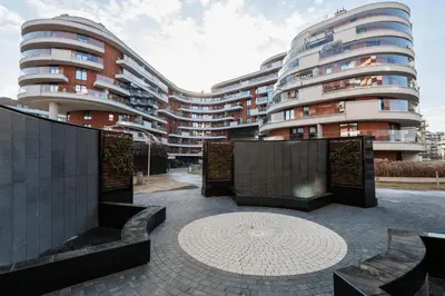 a courtyard with benches in front of a building at City of the Kings-Riverside WT2 in Kraków
