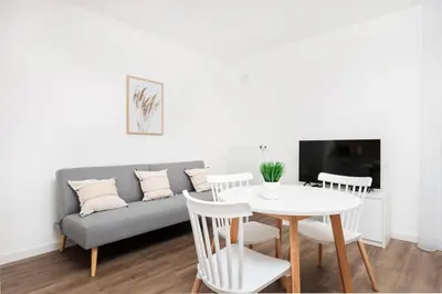 a living room with a couch and a table and chairs at City of the Kings-Riverside WT2 in Kraków