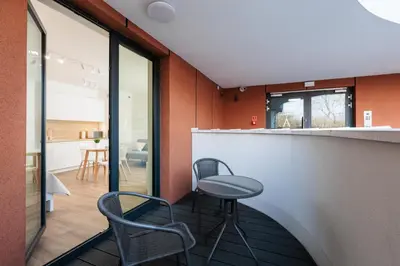 a room with two chairs and a bar with a counter at City of the Kings-Riverside WT2 in Kraków