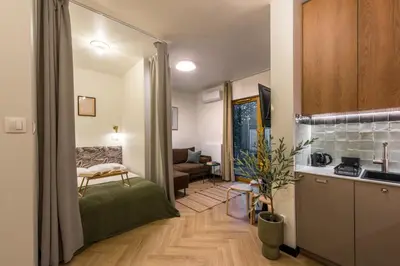 a room with a kitchen and a living room at WLB Apartments Comfort in Kraków