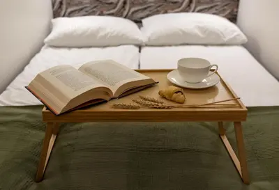 a coffee table with an open book and a cup of coffee at WLB Apartments Comfort in Kraków